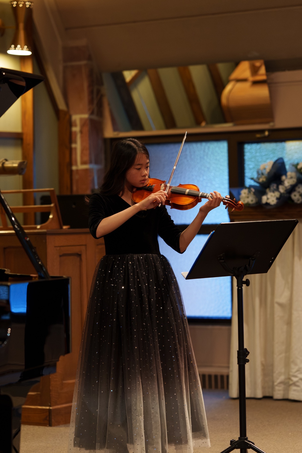 A Las Conchillas Music Academy violin student performing in concert