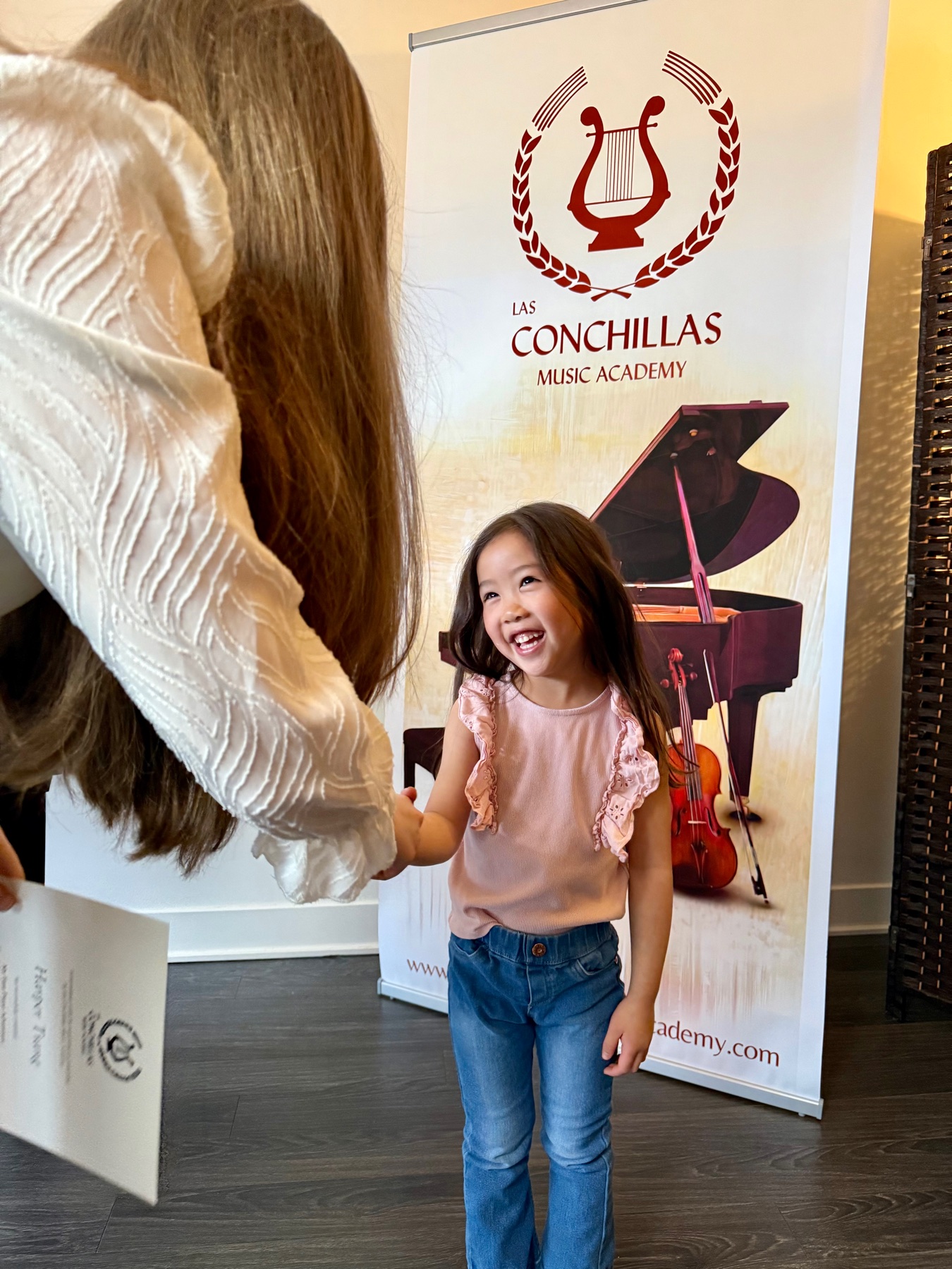 A young student being welcomed at Las Conchillas Music Academy